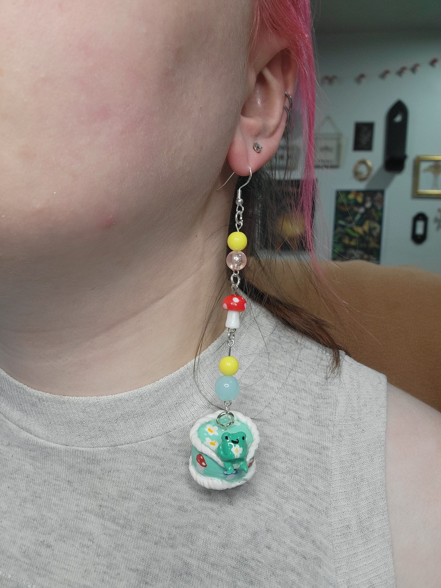 awkward frog on a cute cake earrings