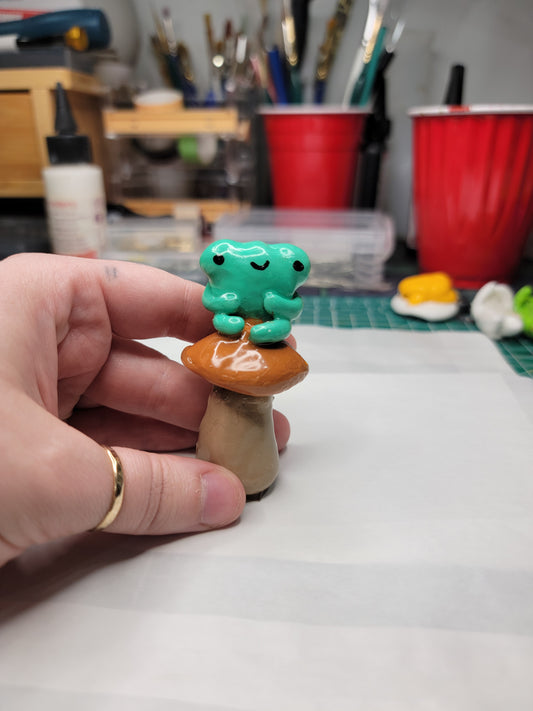 cute frog on a brown mushroom figure