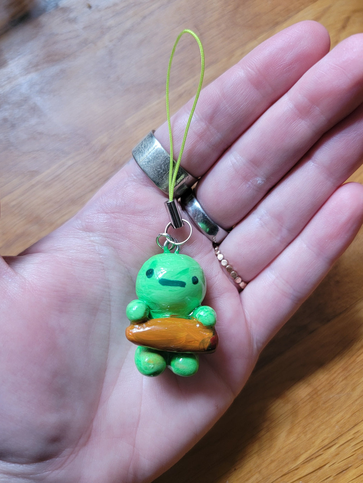 smiski holding a spliff phone strap
