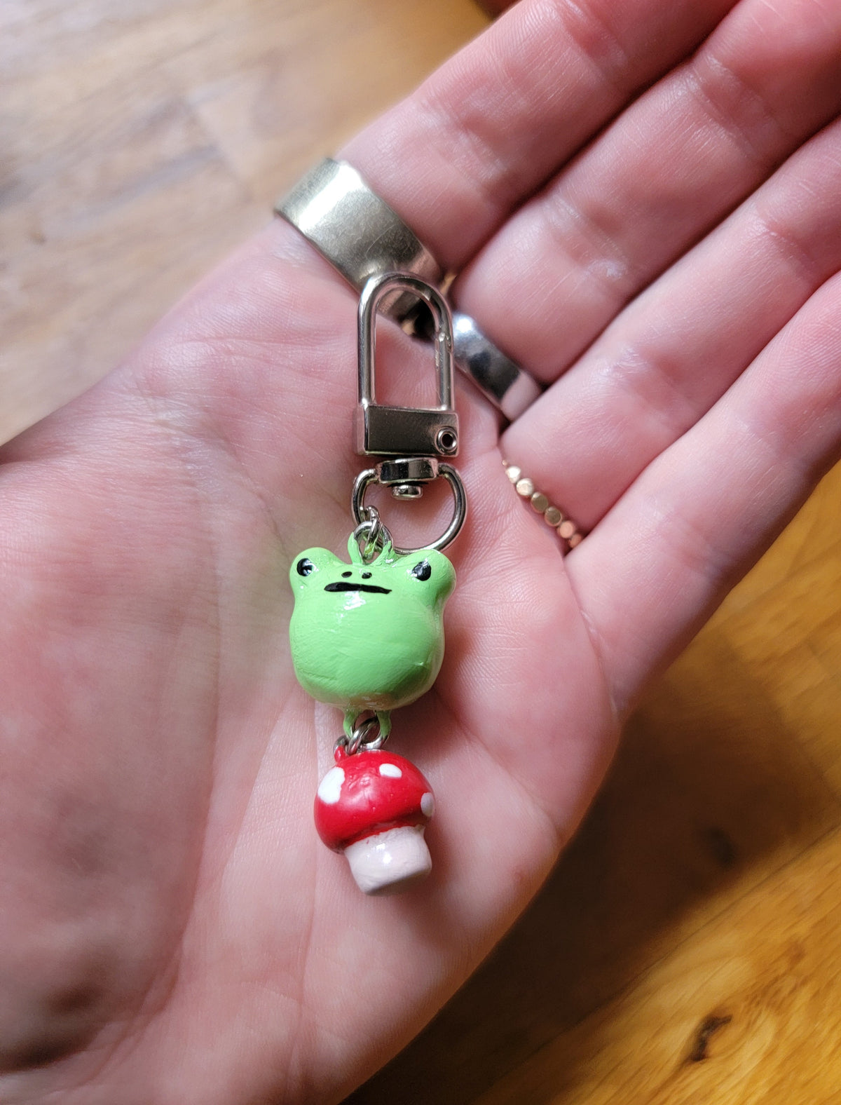 frog sitting on a mushroom keychain