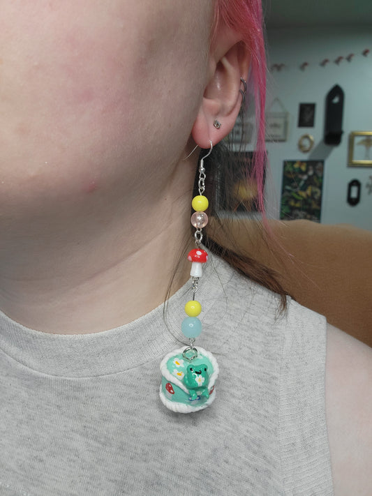 awkward frog on a cute cake earrings
